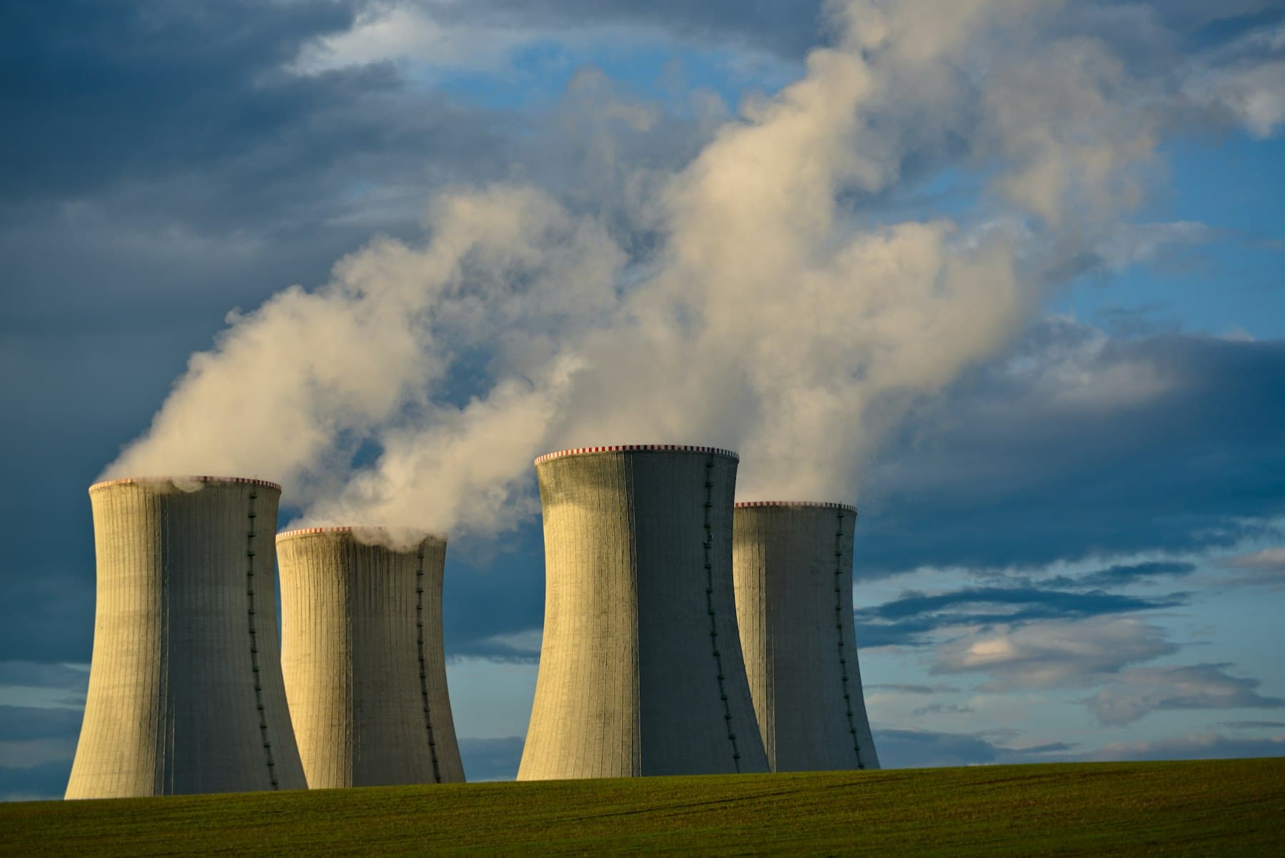 Nuclear power plant cooling towers against a blue sky