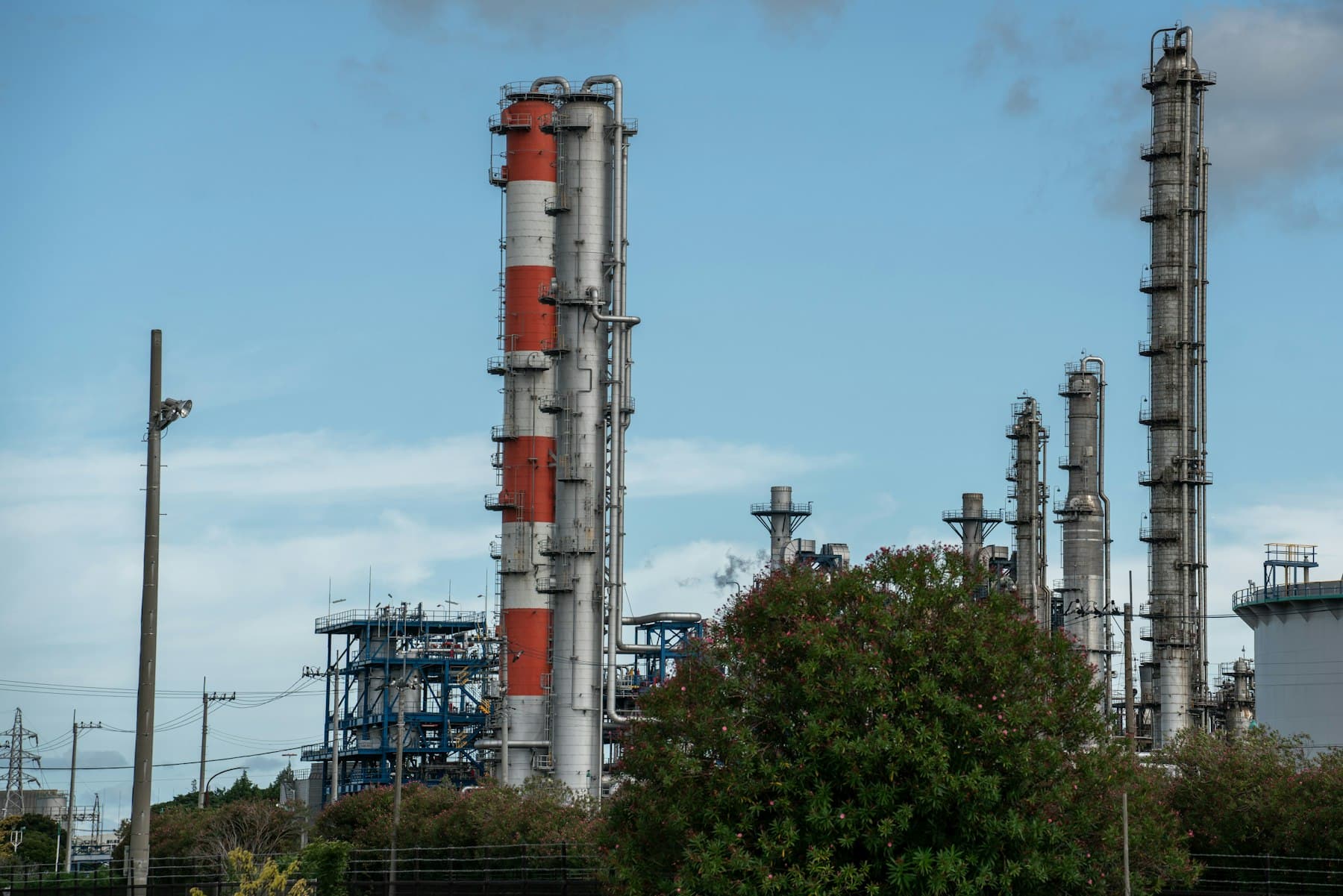 Oil refinery with pipework and processing towers at dusk