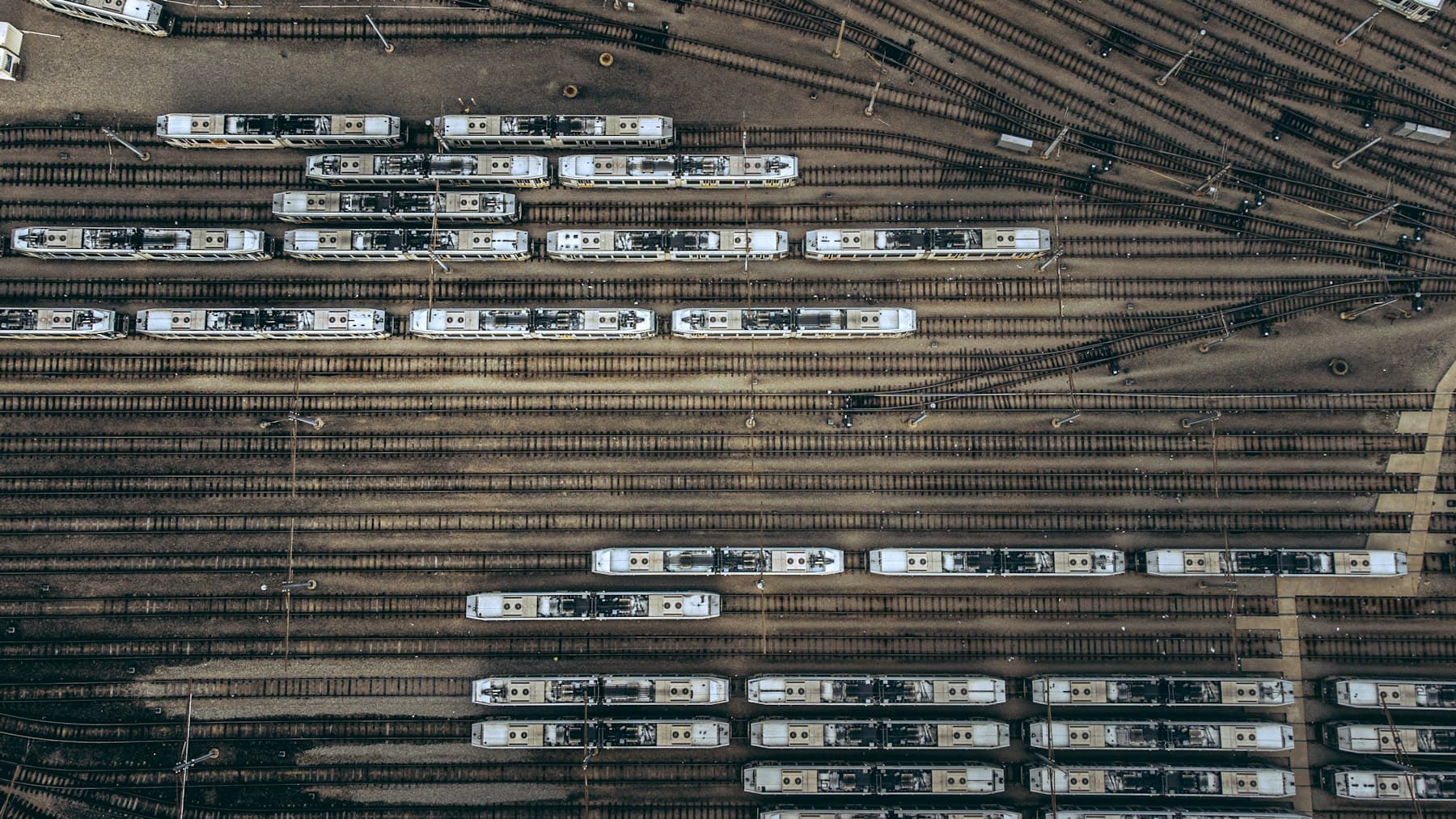 Aerial view of a rail yard with multiple tracks and rolling stock