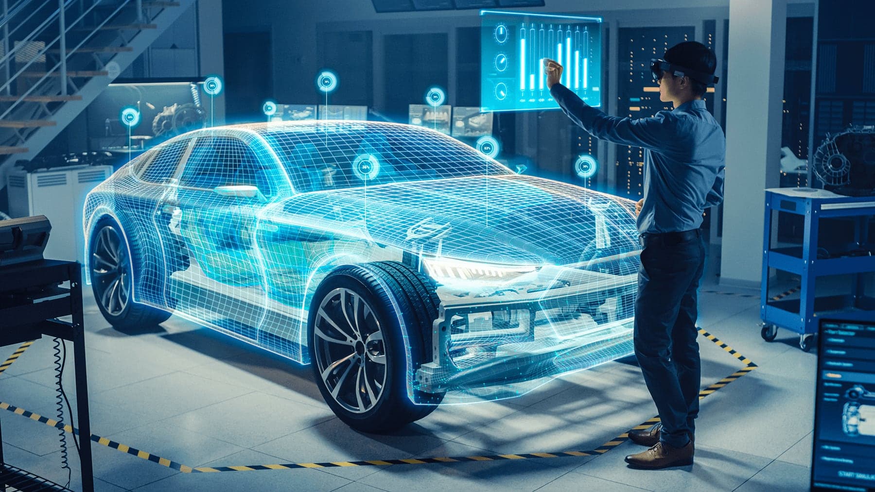 An engineer inspecting a connected vehicle against a projected model of its systems in an engineering bay