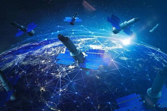 Satellites in orbit above Earth, connected by an overlaid communications network.
