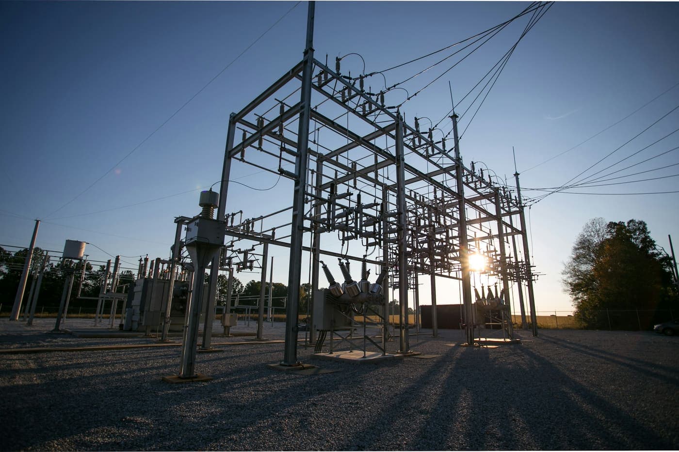 High voltage switchyard structures and disconnect switches at an electrical substation