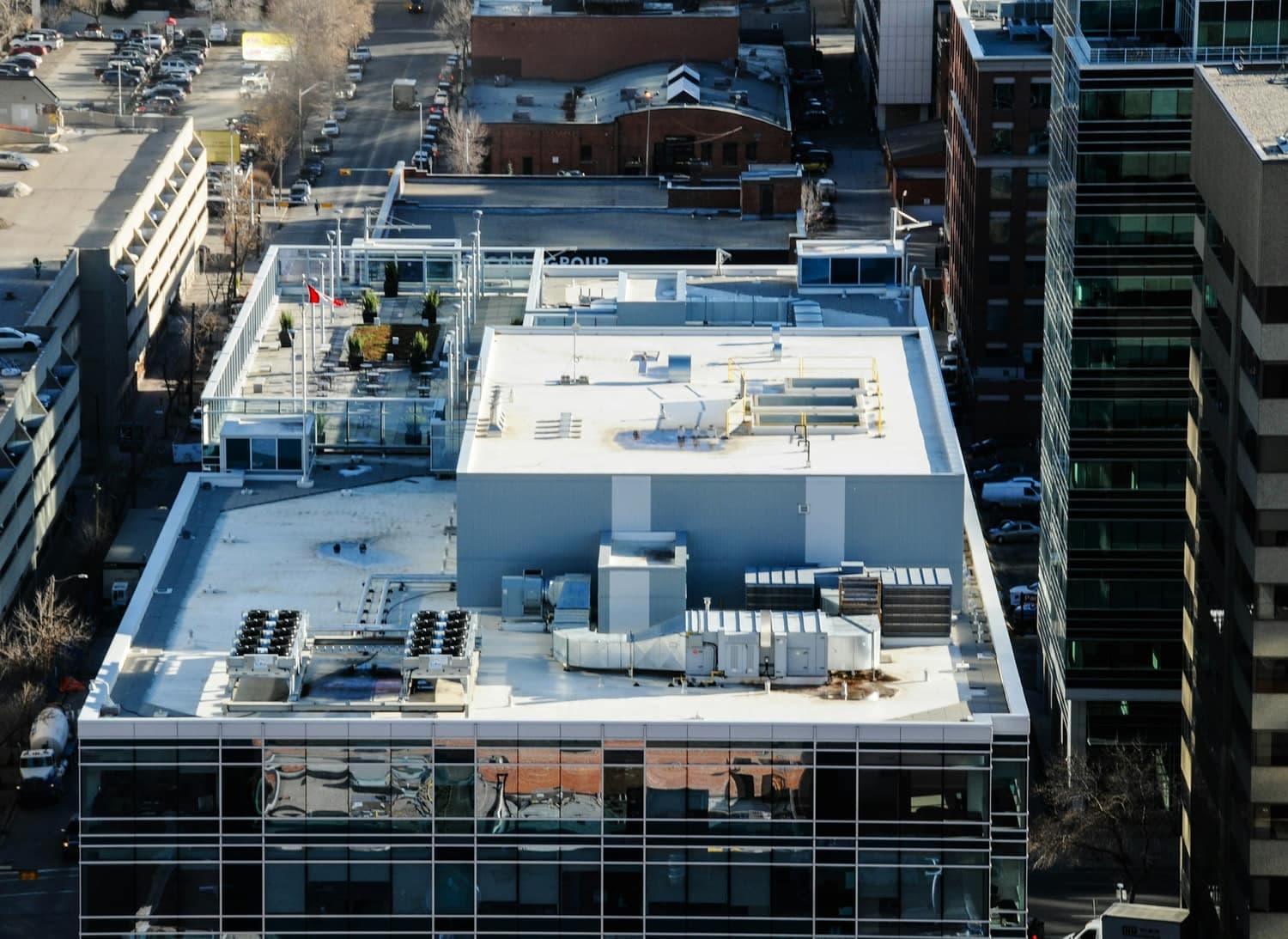 Rooftop of a downtown building carrying air handling units, condenser banks and ductwork