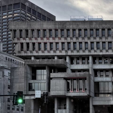 Concrete civic building seen from the street below
