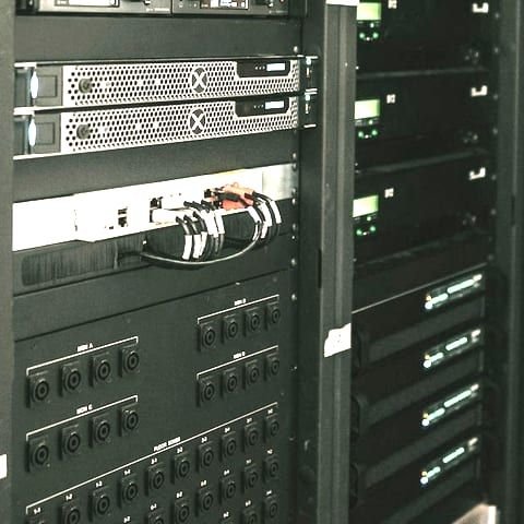 Racked servers, a patch frame and network switches in a communications room